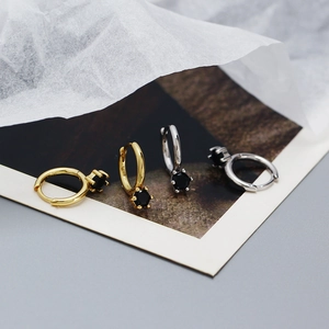 Detailed view of gold and silver S925 sterling silver hoop earrings with black zircon stones