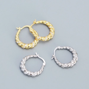 U-shaped twisted hoop earrings in gold and silver with shimmering micro-pave zircons
