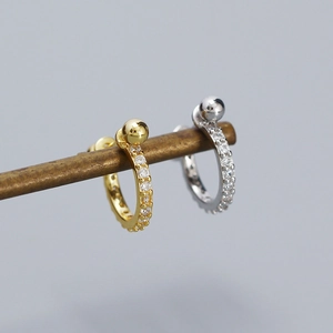 Detailed close-up of s925 silver hoop earrings with micro zircons and metallic spheres