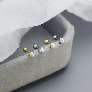 Macro detail of S925 silver pearl stud earrings with secure threaded screw ball backs