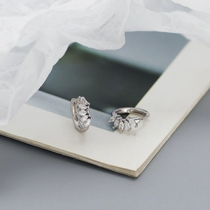 Detailed macro view of S925 sterling silver stamp on marquise zircon huggie earrings