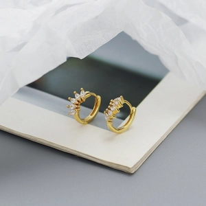 Detail of S925 sterling silver stamp and marquise cubic zirconia on gold hoop earrings