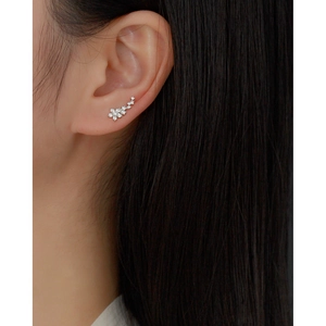 Close-up of S925 silver flower climber earrings with sparkling cubic zirconia stones