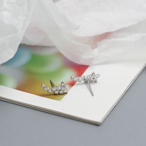 Macro shot of silver flower earrings featuring sparkling cubic zirconia in a cluster design