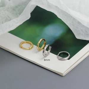 Detailed macro view of 8mm S925 sterling silver hoop earrings in gold and silver finish