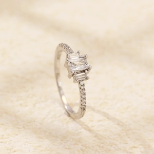 Detail of s925 silver ring featuring rectangular zircon stones and a pavé diamond band