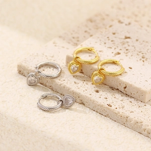 Detail of S925 silver heart earrings with twisted hoops in gold and silver finish
