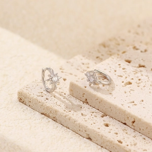 Detail showing S925 hallmark on silver star earrings with sparkling cubic zirconia