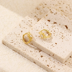 Detailed view of gold S925 sterling silver star hoop earrings with sparkling zircon stones