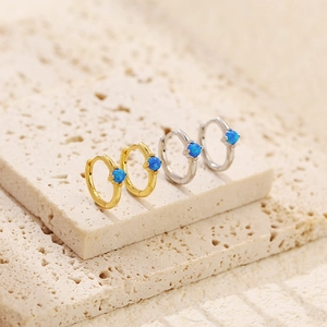 Detailed close-up of blue opal stone inlays on gold and silver plated earrings
