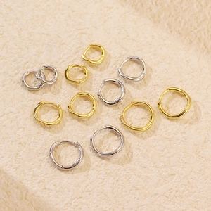 Detailed top view of various minimalist gold and silver s925 wavy irregular hoop earrings