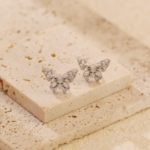 Macro detail of S925 silver butterfly earrings featuring marquise-cut cubic zirconia