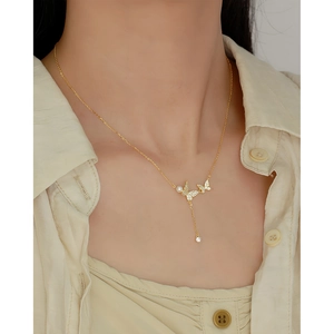 Close-up of S925 silver butterfly necklace with tassel pearl and sparkling diamonds
