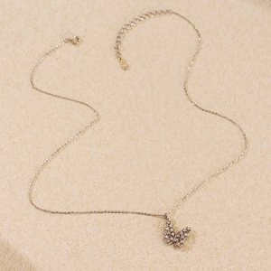 Macro shot of S925 sterling silver butterfly necklace with lobster clasp and heart tag