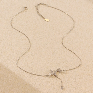 Detail view of S925 silver butterfly necklace with sparkling zircon and pearl pendant