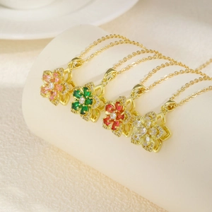 Gold-plated floral pendant necklace featuring rotating petals in pink, green, red and white