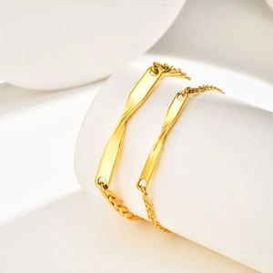Elegant gold Mobius strip stainless steel bracelet pair with minimalist twisted design