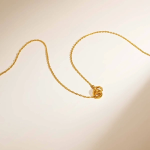 Golden stainless steel interlocking rings necklace with smooth and twisted textures