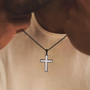 Minimalist two-tone stainless steel cross pendant necklace worn by male model