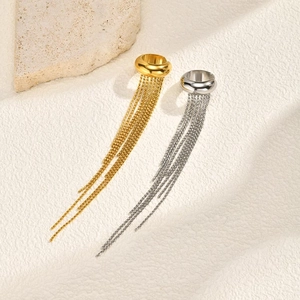 Elegant gold and silver stainless steel tassel earrings on a minimalist stone background