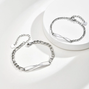 Pair of minimalist stainless steel Mobius bracelets with polished Figaro chain