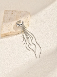 Detailed close-up of a silver non-pierced ear cuff with elegant long tassel chains on stone