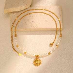 Detail of sunflower pendant necklace with pearls and S.steel engraved metal tag
