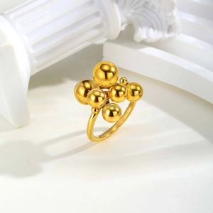 Macro detail of gold-plated stainless steel ring with polished bead cluster design