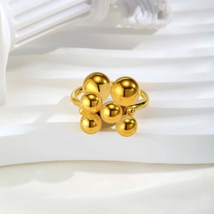 Detailed close-up of golden multi-sphere cluster ring with polished stacked balls