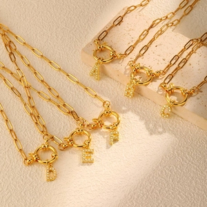 Detail of gold paperclip chain necklaces with micro-pave letter pendants A to F