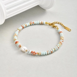 Detail of stainless steel bead bracelet with colorful crystals and a freshwater pearl
