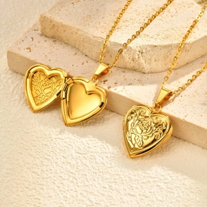 Close-up of a golden heart locket necklace featuring a detailed rose relief pattern