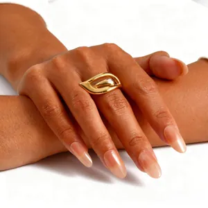Detail of 18K gold-plated wing ring with hollow design on finger, elegant style