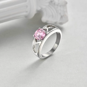 Detailed close-up of a pink zircon ring featuring a hollow wave-textured band and silver finish