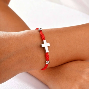 Adjustable red braided rope bracelet with a stainless steel cross pendant and silver beads