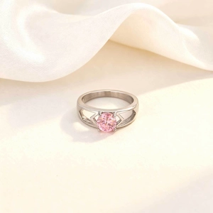 Detail of pink zircon ring with geometric hollow design on silver stainless steel band