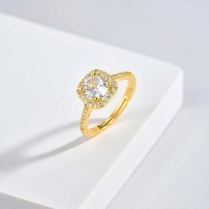 Macro shot of gold adjustable ring with round green zircon and halo diamond setting