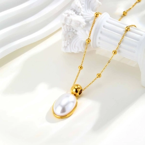 Elegant gold-plated bead chain necklace featuring a large oval faux pearl pendant