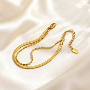 Gold double-layered stainless steel bracelet featuring flat snake and bead chains