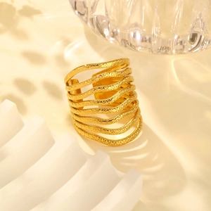 Close-up of a wide multilayer wave ring in gold finish with textured metal details