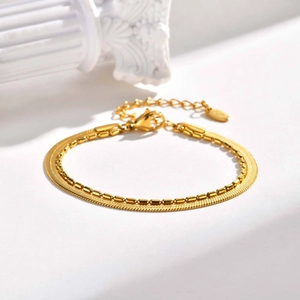 Detail of double-layer golden stainless steel snake and bead chain with lobster clasp