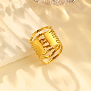 Macro shot of gold wide multi-layer wave ring on aesthetic white stone background