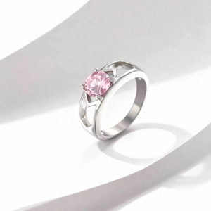 Polished stainless steel ring with pink zircon gemstone and heart-shaped hollow band