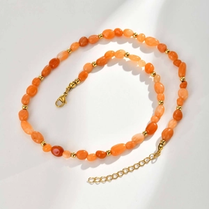 Detail of natural orange stone beaded necklace with stainless steel gold chain links