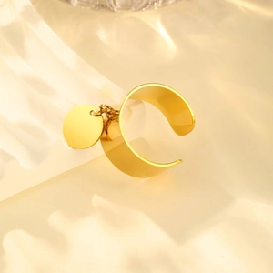 Detailed close-up of a gold-plated stainless steel ring with a round turquoise pendant