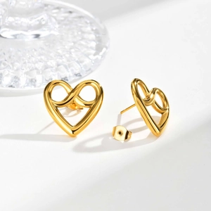 Close-up of golden infinity heart stud earrings with polished hollow design and butterfly backs