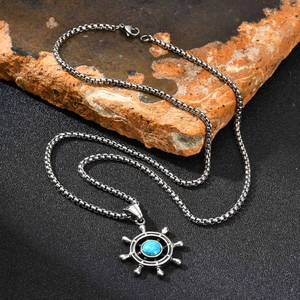 Vintage stainless steel nautical rudder pendant with turquoise stone on rock base