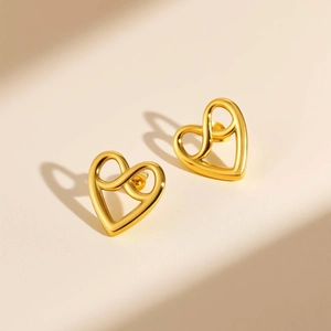 Minimalist gold heart stud earrings with infinity symbol design and polished finish