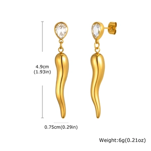 Macro detail of gold horn drop earrings with tear-shaped cubic zirconia on white background