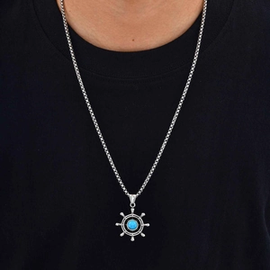 Vintage stainless steel ship wheel necklace with turquoise stone inlay on black t-shirt